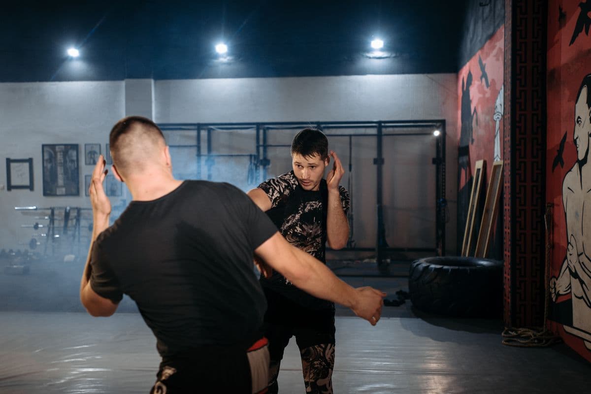 Two adults practicing a partner self-defense drill
